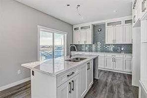 1409 Price Close, Carstairs, AB - Indoor Photo Showing Kitchen With Double Sink With Upgraded Kitchen