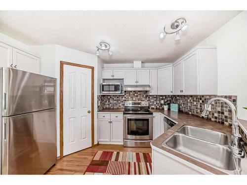 12 Cramond Drive Se, Calgary, AB - Indoor Photo Showing Kitchen With Double Sink