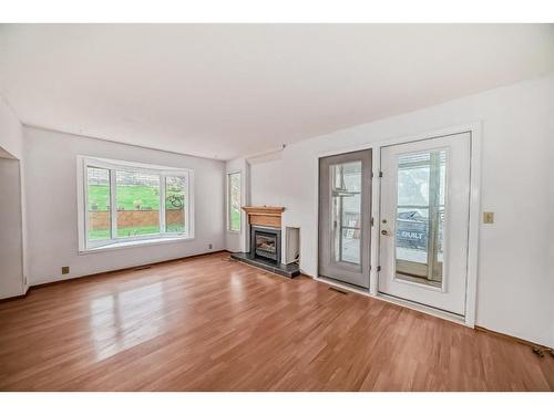 973 Ranchview Crescent Nw, Calgary, AB - Indoor Photo Showing Living Room With Fireplace