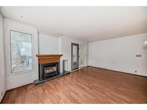 973 Ranchview Crescent Nw, Calgary, AB - Indoor Photo Showing Living Room With Fireplace