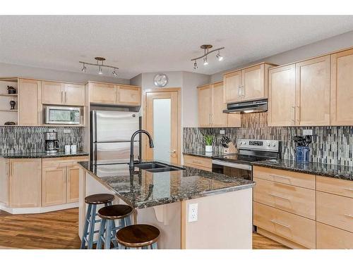 687 Tuscany Drive Nw, Calgary, AB - Indoor Photo Showing Kitchen With Double Sink With Upgraded Kitchen
