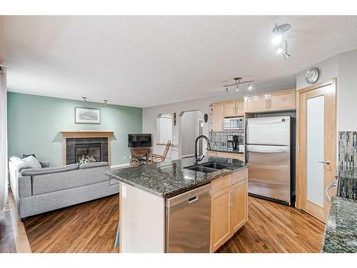 687 Tuscany Drive Nw, Calgary, AB - Indoor Photo Showing Kitchen With Fireplace With Double Sink