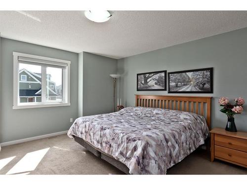 107-2400 Ravenswood View Se, Airdrie, AB - Indoor Photo Showing Bedroom