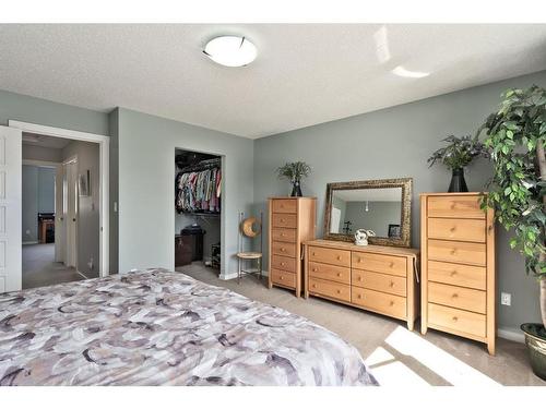 107-2400 Ravenswood View Se, Airdrie, AB - Indoor Photo Showing Bedroom
