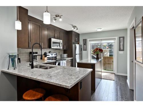 107-2400 Ravenswood View Se, Airdrie, AB - Indoor Photo Showing Kitchen With Double Sink With Upgraded Kitchen