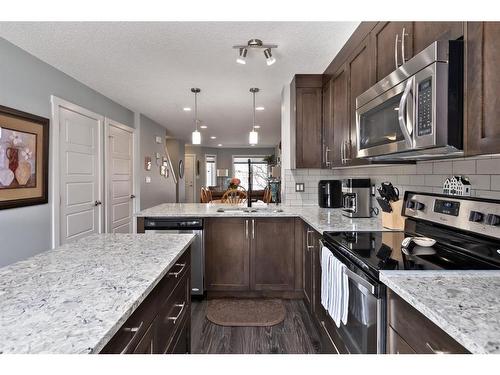 107-2400 Ravenswood View Se, Airdrie, AB - Indoor Photo Showing Kitchen With Upgraded Kitchen