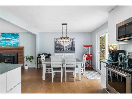 7127 20 Street Se, Calgary, AB - Indoor Photo Showing Dining Room With Fireplace