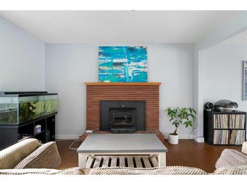 7127 20 Street Se, Calgary, AB - Indoor Photo Showing Living Room With Fireplace