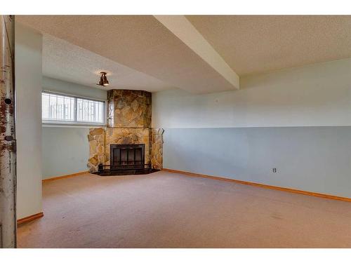 24 Radcliffe Bay Se, Calgary, AB - Indoor With Fireplace