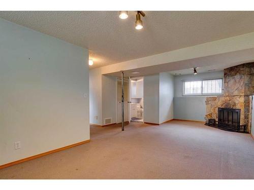 24 Radcliffe Bay Se, Calgary, AB - Indoor With Fireplace