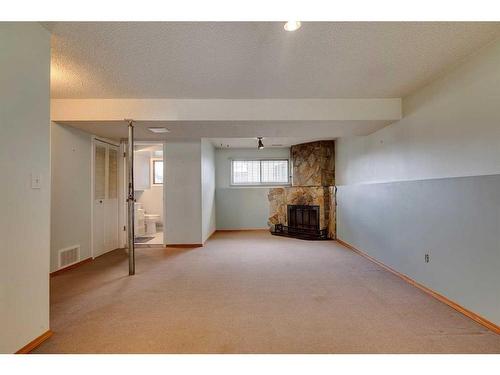 24 Radcliffe Bay Se, Calgary, AB - Indoor With Fireplace