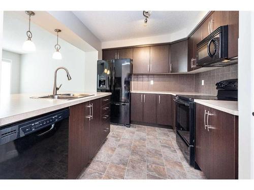 104 Windstone Link Sw, Airdrie, AB - Indoor Photo Showing Kitchen With Double Sink