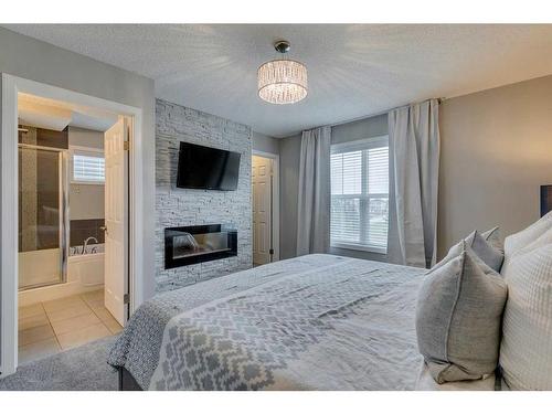258 Auburn Crest Green Se, Calgary, AB - Indoor Photo Showing Bedroom With Fireplace