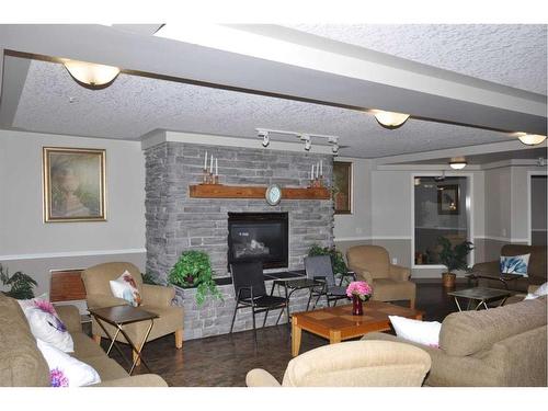 3412-3000 Millrise Point Sw, Calgary, AB - Indoor Photo Showing Living Room With Fireplace