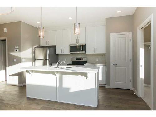 24 Emberside Grove, Cochrane, AB - Indoor Photo Showing Kitchen With Double Sink With Upgraded Kitchen