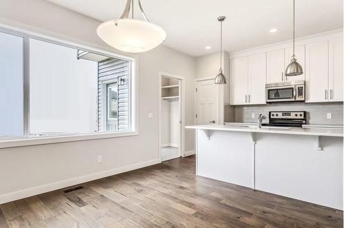 24 Emberside Grove, Cochrane, AB - Indoor Photo Showing Kitchen With Upgraded Kitchen