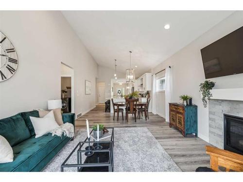 78 Bayview Circle Sw, Airdrie, AB - Indoor Photo Showing Living Room With Fireplace