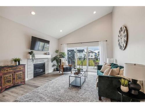 78 Bayview Circle Sw, Airdrie, AB - Indoor Photo Showing Living Room With Fireplace