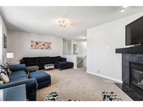 83 Chapala Way Se, Calgary, AB - Indoor Photo Showing Living Room With Fireplace