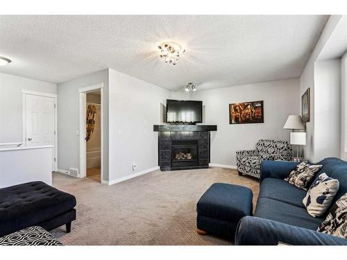 83 Chapala Way Se, Calgary, AB - Indoor Photo Showing Living Room With Fireplace
