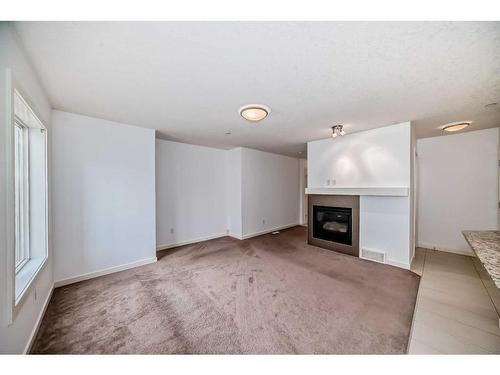 64 Covecreek Mews Ne, Calgary, AB - Indoor Photo Showing Living Room With Fireplace