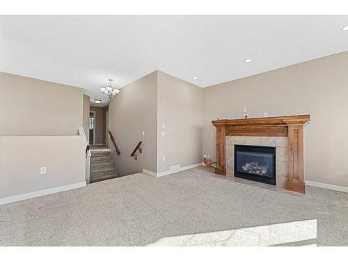 580 Cranston Drive Se, Calgary, AB - Indoor Photo Showing Living Room With Fireplace