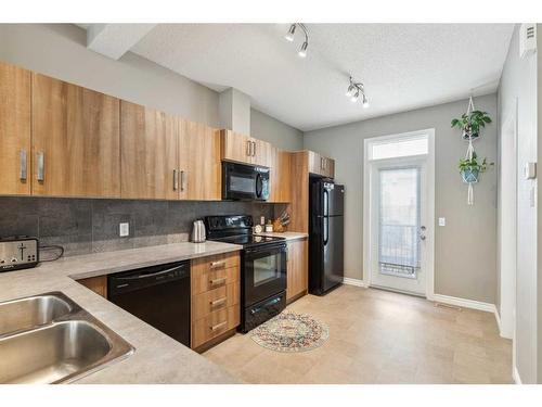 220 New Brighton Row Se, Calgary, AB - Indoor Photo Showing Kitchen With Double Sink