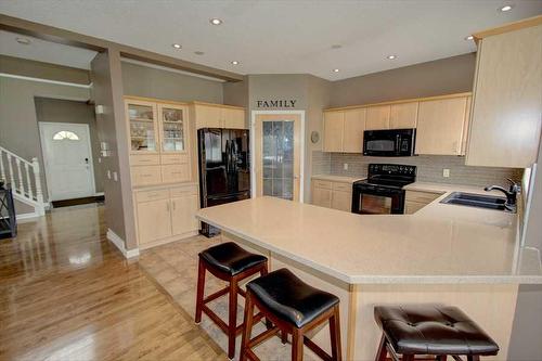 418 Bridlewood Place Sw, Calgary, AB - Indoor Photo Showing Kitchen With Double Sink