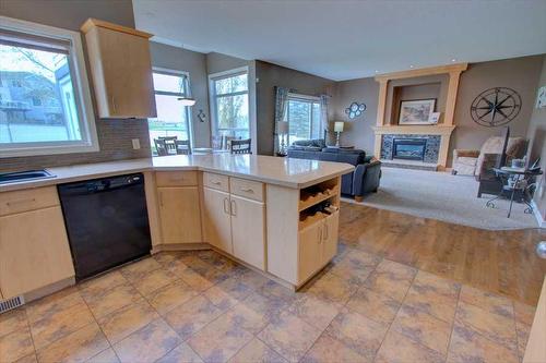 418 Bridlewood Place Sw, Calgary, AB - Indoor Photo Showing Kitchen With Fireplace