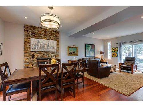 916 Mapleglade Drive Se, Calgary, AB - Indoor Photo Showing Dining Room With Fireplace