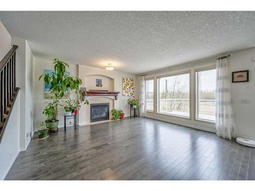 128 Tuscany Ravine Terrace Nw, Calgary, AB - Indoor Photo Showing Living Room With Fireplace