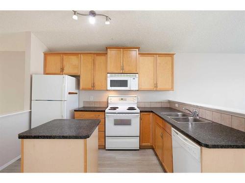 435 Evermeadow Road Sw, Calgary, AB - Indoor Photo Showing Kitchen With Double Sink