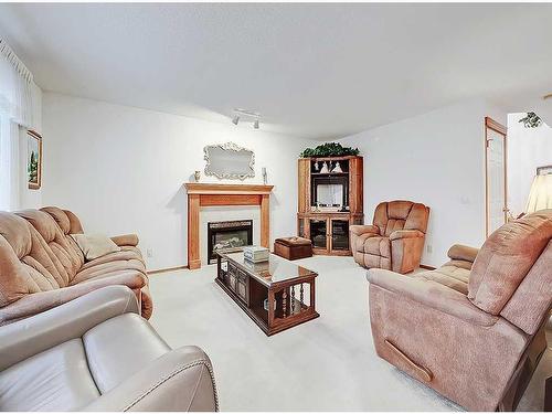 76 Somerset Manor Sw, Calgary, AB - Indoor Photo Showing Living Room With Fireplace