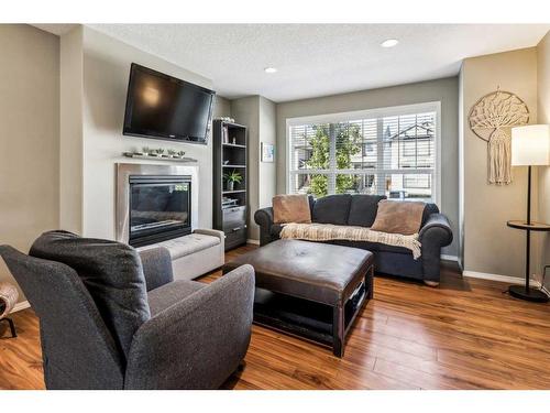 115 Cranford Close Se, Calgary, AB - Indoor Photo Showing Living Room With Fireplace