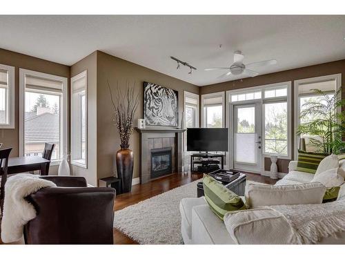 202-2121 98 Avenue Sw, Calgary, AB - Indoor Photo Showing Living Room With Fireplace