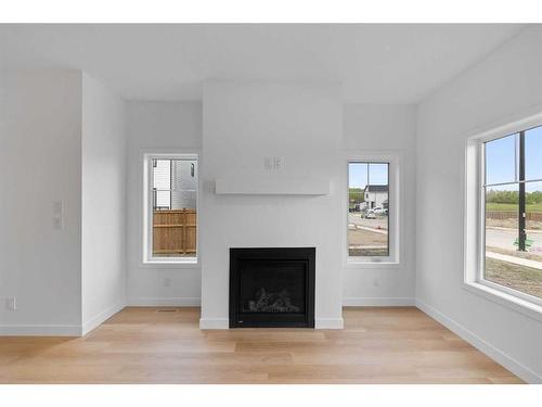 187 Baneberry Way Sw, Airdrie, AB - Indoor Photo Showing Living Room With Fireplace