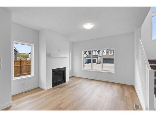 187 Baneberry Way Sw, Airdrie, AB - Indoor Photo Showing Living Room With Fireplace