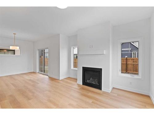 187 Baneberry Way Sw, Airdrie, AB - Indoor Photo Showing Living Room With Fireplace