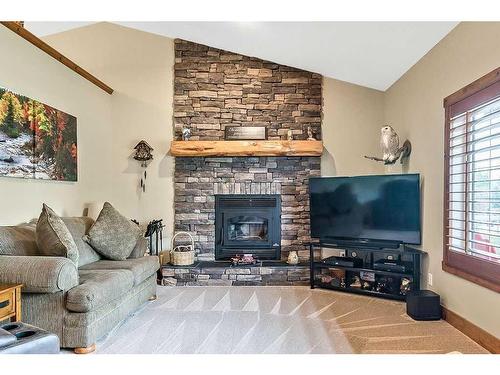 112 Derochie Drive, Claresholm, AB - Indoor Photo Showing Living Room With Fireplace