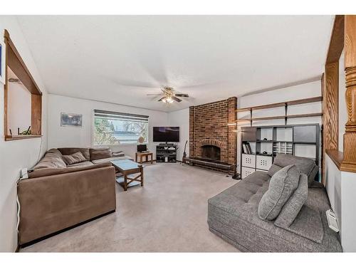 231 Penmeadows Close Se, Calgary, AB - Indoor Photo Showing Living Room With Fireplace