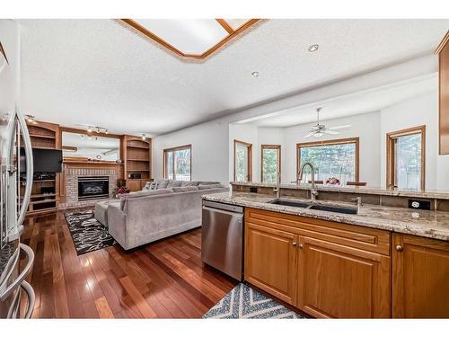 15880 Mckenzie Lake Way Se, Calgary, AB - Indoor Photo Showing Kitchen With Fireplace With Double Sink