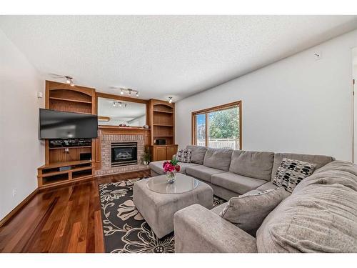 15880 Mckenzie Lake Way Se, Calgary, AB - Indoor Photo Showing Living Room With Fireplace