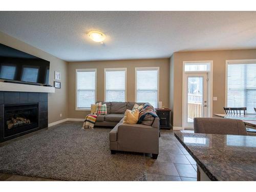 197 Cranarch Crescent Se, Calgary, AB - Indoor Photo Showing Living Room With Fireplace