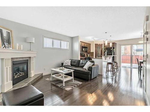 524 Cranston Drive Se, Calgary, AB - Indoor Photo Showing Living Room With Fireplace