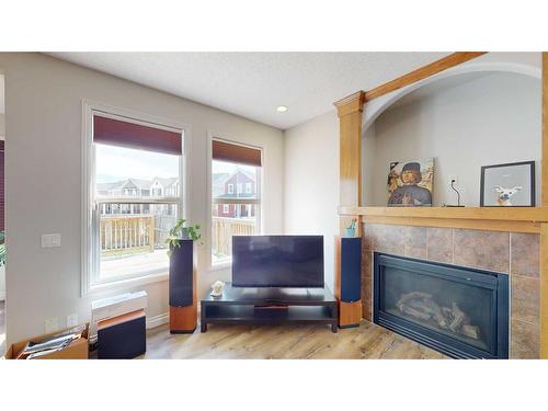 94 Copperleaf Terrace Se, Calgary, AB - Indoor Photo Showing Living Room With Fireplace