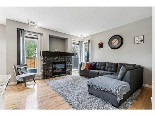 12 Cranberry Gardens Se, Calgary, AB - Indoor Photo Showing Living Room With Fireplace