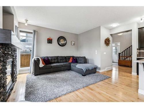 12 Cranberry Gardens Se, Calgary, AB - Indoor Photo Showing Living Room With Fireplace