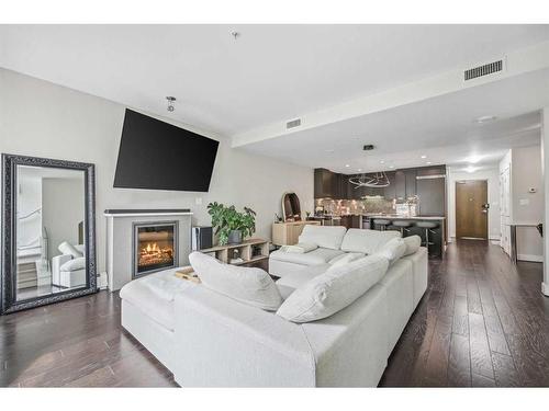 132-99 Spruce Place Sw, Calgary, AB - Indoor Photo Showing Living Room With Fireplace