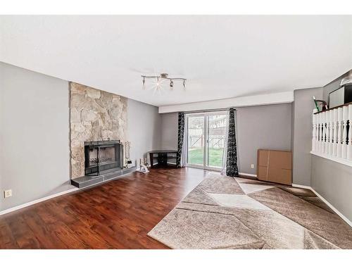 4630 43 Street Ne, Calgary, AB - Indoor Photo Showing Living Room With Fireplace