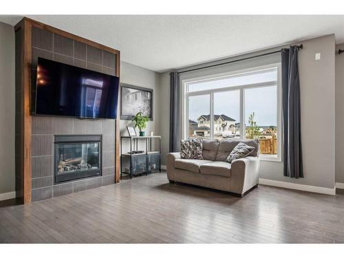 149 Heritage Boulevard West, Cochrane, AB - Indoor Photo Showing Living Room With Fireplace